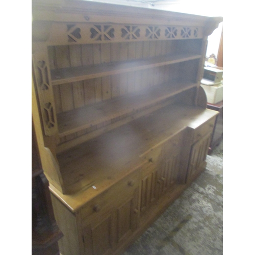 42 - A modern large pine dresser having a plate rack with two shelves above four drawers and four cupboar... 