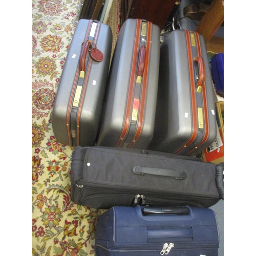 24 - Three Samsonite suitcases with mid brown leather handles and trim together with a black Antler suit ... 