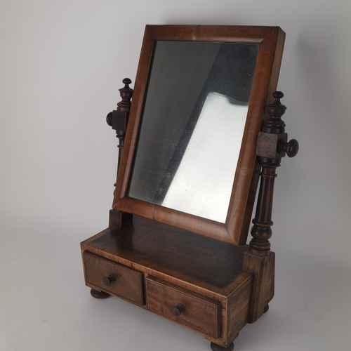 48 - An early 19th century walnut swivel dressing table mirror with two drawers below
Location: G