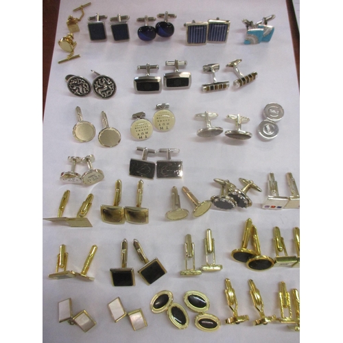 13 - A collection of mixed modern gold tone and silver tone cuff links to include Colibri and silver exam... 