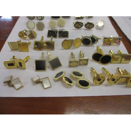 13 - A collection of mixed modern gold tone and silver tone cuff links to include Colibri and silver exam... 