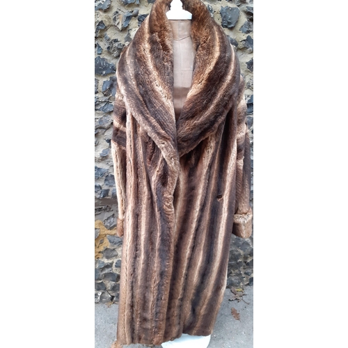 A Retro French stranded dyed rabbit full length coat with shawl collar and leather buttons A/F, up to 44" chest x 46" long .
Condition: There are multiple small dotted stains to the lower lining and the extra buckle fastening to the exterior shoulder requires repair-see additional photos.
Location: RWB