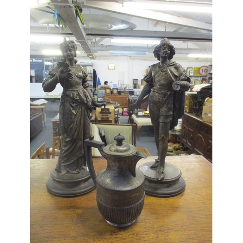 12 - A pair of good French patinated spelter courtier figurines on raised circular bases, and a silver pl... 