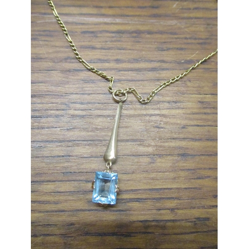 17 - A 9ct yellow gold pendant set with a square cut aquamarine coloured stone drop, on a 9ct gold neckla... 