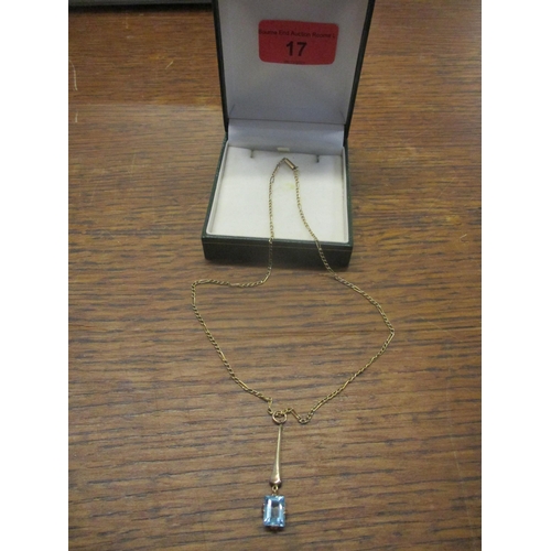17 - A 9ct yellow gold pendant set with a square cut aquamarine coloured stone drop, on a 9ct gold neckla... 
