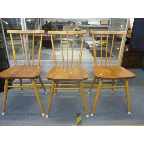 52 - A set of three Ercol 391 stick back chairs in elm and beech, remains of label to back of two chairs
... 