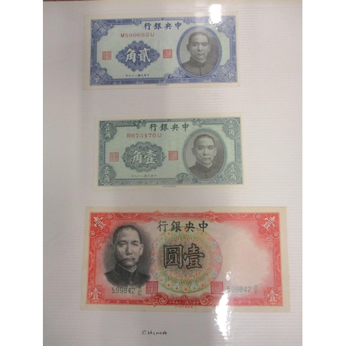 55 - An album of banknotes from around the world to include Argentina, China, Holland, USA, British and I... 