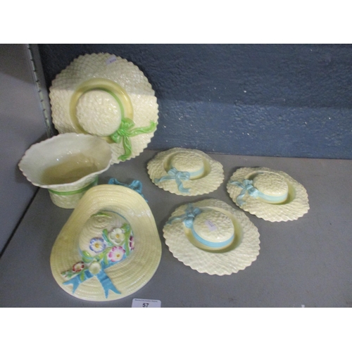 57 - Falcon Ware pottery comprising four small hat posy bowls, and a larger version with green painted ri... 