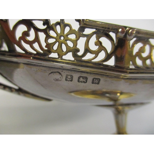 6 - An early 20th century silver bon bon dish with pierced rim, knopped column and on an oval base, hall... 