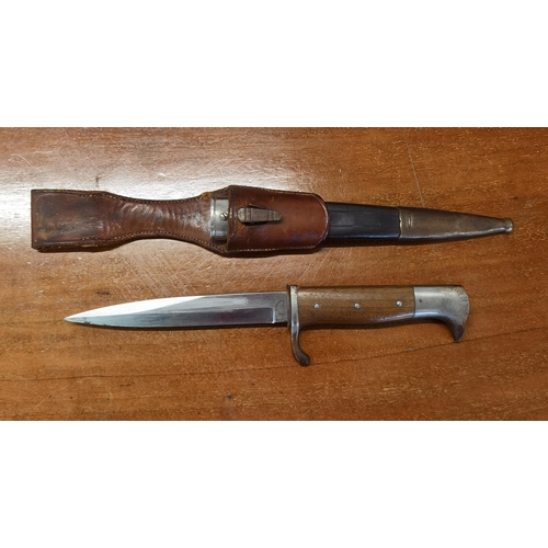 49 - A WWI German trench knife/dagger, blade engraved Carl Eickhorn Holingen, having an eagle head pommel... 