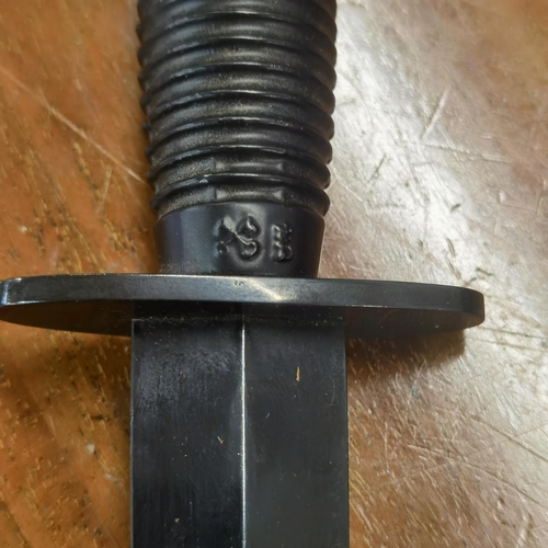 51 - A pair of reproduction commando style daggers with scabbards, one with a matt black handle and other... 