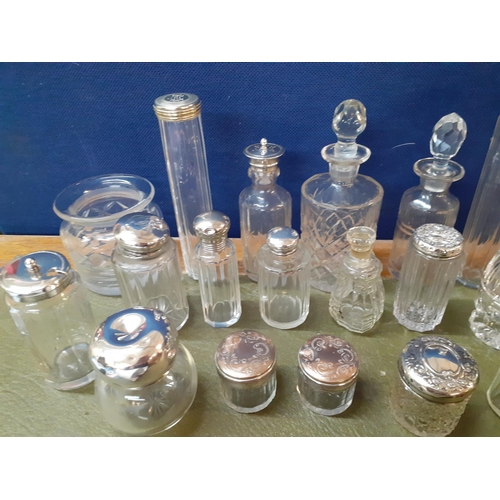 12 - A collection of 20th Century dressing table bottles with silver or silver plated lids together with ... 