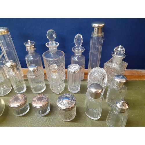 12 - A collection of 20th Century dressing table bottles with silver or silver plated lids together with ... 