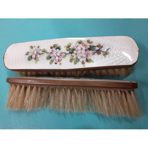 32 - An Art Deco silver and green enamelled back hand mirror and 2 matching brushes A/F, together with a ... 