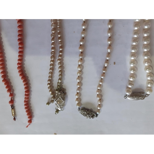 41 - A string of pink coral beads on a 9ct gold clasp A/F, together with 2 pearl necklaces having silver ... 