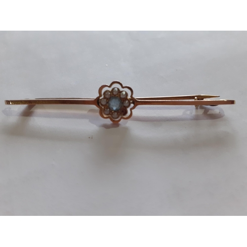 45 - A 9ct gold bar brooch with central flower design inset with seed pearls (one deficient) surrounding ... 