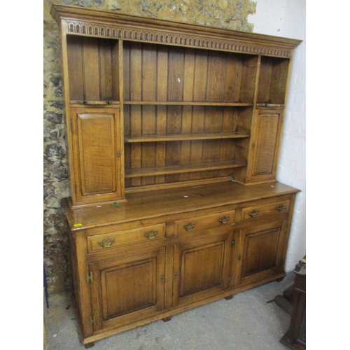A reproduction oak dresser having a plate rack above three drawers and three panelled cupboard doors 192cm h x 169cm w
Location:G