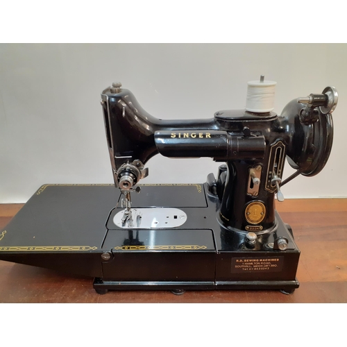 21 - A Singer 222K featherweight free arm sewing machine in original case with accessories, circa 1950's ... 