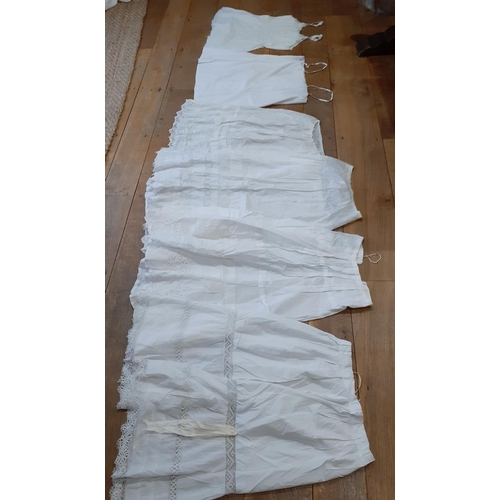 24 - Vintage ladies white cotton garments to include 4 mixed underskirts with lace trim (waistband to one... 