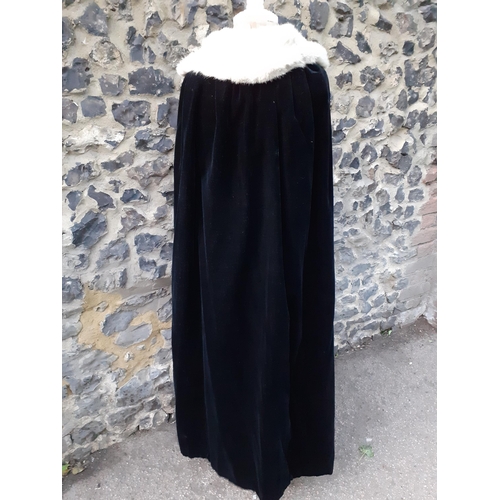 31 - A Bourne & Hollingsworth black velvet opera cape with salmon pink silk lining and a grey rabbit fur ... 