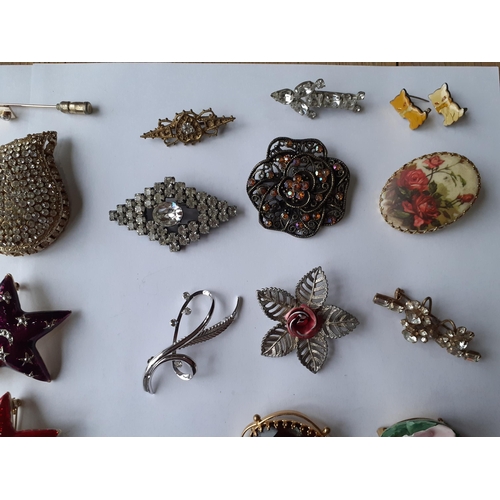 60 - Vintage brooches to include modern enamelled star brooches, a sterling silver brooch in the form of ... 