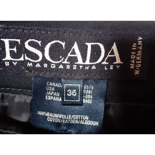 27 - Escada- A 1980's black knee length skirt with side slit and gold coloured button detail by Margareth... 