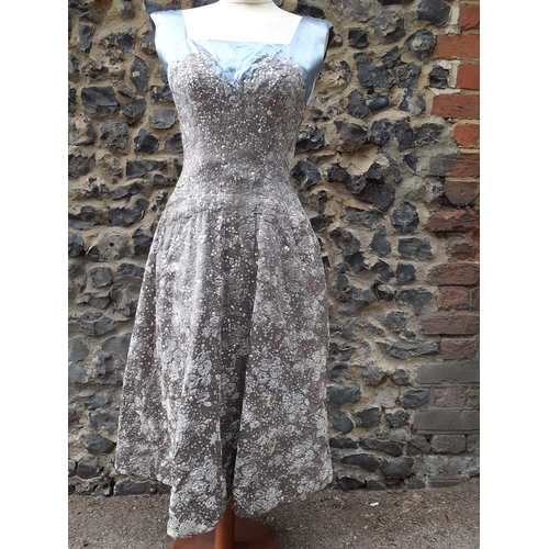 8 - Norman Hartnell-A 1950's grey and silver sequinned and sleeveless cocktail dress, with grey satin ne... 