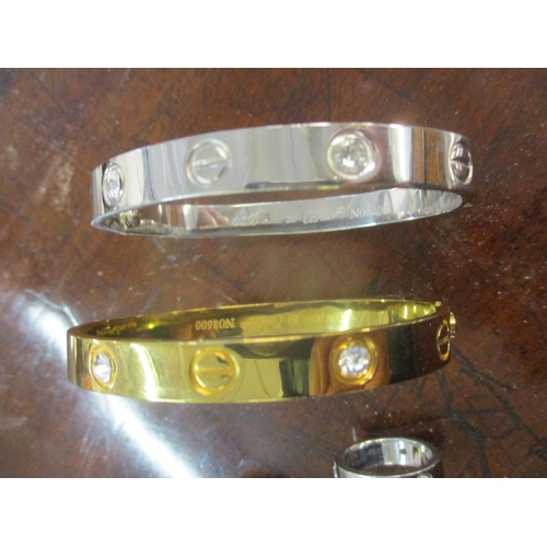 9 - A yellow and white gold coloured bracelet with an interlocking design to the centre, stamped marks t... 