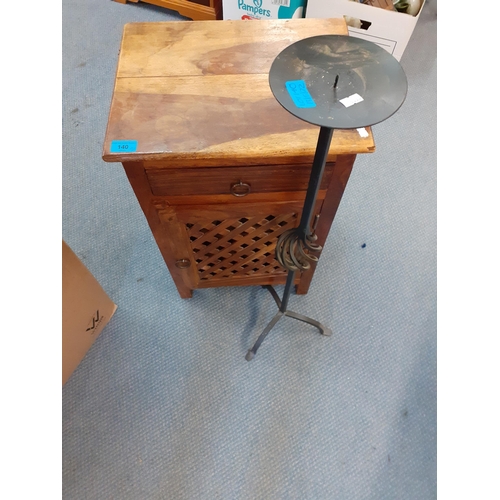 23 - A small hardwood bedside cabinet with fretwork door together with a wrought iron, floor standing can... 