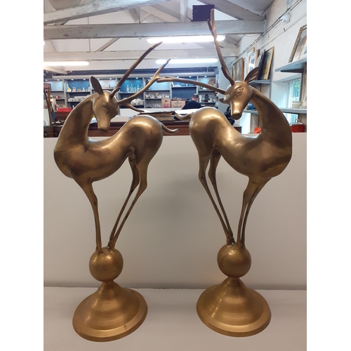 27 - A pair of late 20th century Art Deco style model deer, on a ball and plinth, 75cm h, Location: BWR