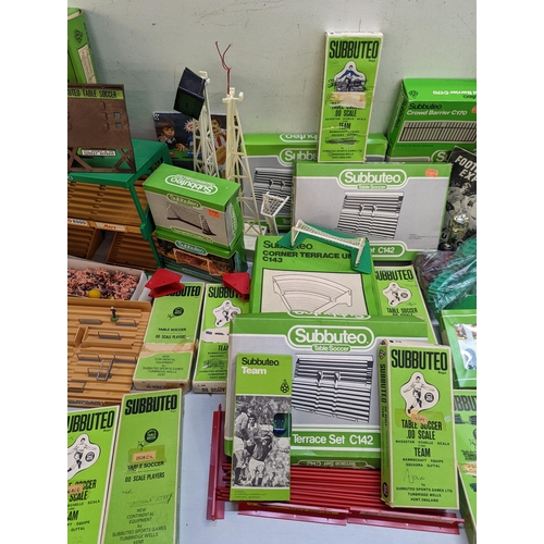 12 - A large collection of Subbuteo items to include teams, spectators, accessories, stands and other ite... 