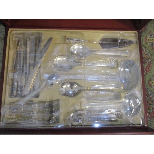 53 - A cased set of SBS stainless steel and gilded cutlery set, Location: SL