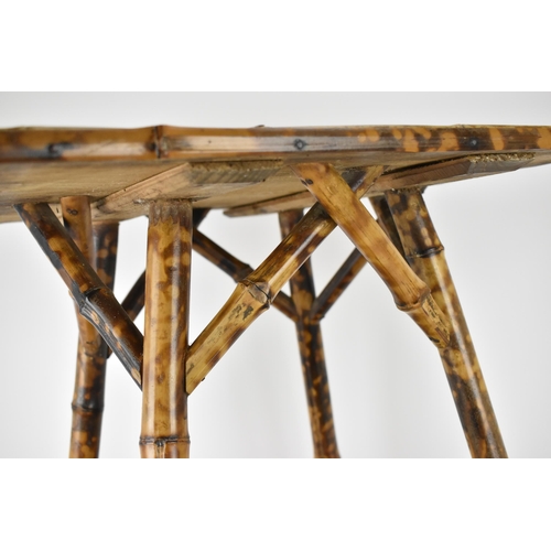 54 - A late 19th century bamboo two tier occasional table, with hessian surfaces, on splayed legs, 64cm h... 