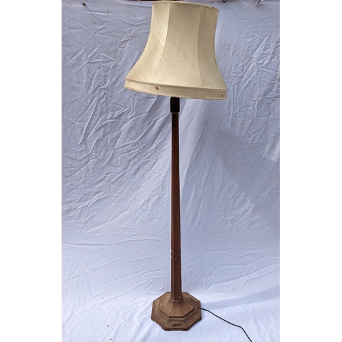 28 - Robert 'Mouseman' Thompson of Kilburn (1876-1955), an oak standard lamp of faceted tapered form, on ... 