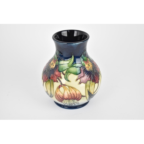 50 - A Moorcroft pottery 'Anne Lily' baluster vase, designed by Nicola Slaney, with tubelined floral deco... 