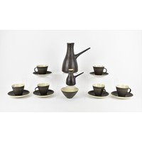 ‡ Dame Lucie Rie DBE (1902-1995), a stoneware coffee set, comprising a coffee pot, milk jug, sugar bowl and six cups and saucers, all in the same pattern with sgraffito lines on a matt brown manganese glaze, artist's seal impressed to underside, teapot 22 cm high