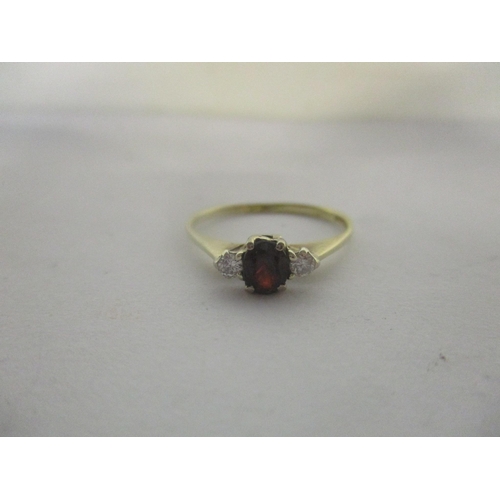 43 - A 9ct gold ring set with a garnet and diamonds, 1.3g
Location: RING