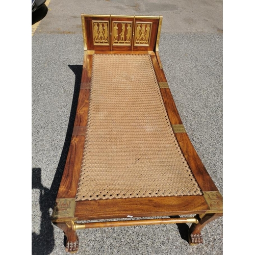 37 - An Egyptian Revival chaise longue, the mahogany frame with gilt carved panels depicting relief Egypt... 