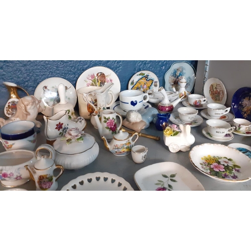 50 - A collection of miniature collectables to include tea cups and plates. Location:9:2