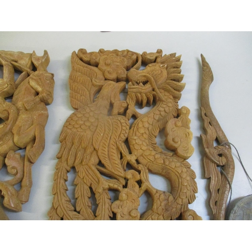 57 - A pair of teak carved Thai panels, one depicting a dragon and the other of a figure of a chariot, to... 