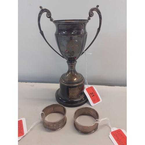 21 - A silver plated 1950's trophy together with two silver napkin rings, 28.3g
Location: 3.1