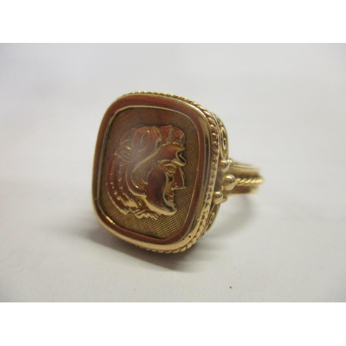 22 - A gents gold coloured ring, the tablet decorated with a mans head, stamped 18k, 8.25g
Location: RING