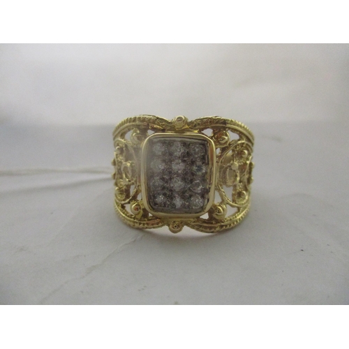 31 - A 14 carat yellow and white gold diamond ornate tablet style ring, a centre white gold tablet with t... 