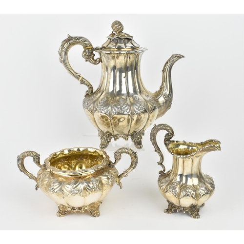 A Victorian silver three piece matching tea set, the teapot by the Goldsmiths Alliance Ltd, London 1879, with lobbed body decorated with leaf and floral cast motifs, the hinged lid stamped for A B Savory & Sons (William Smily), with fruit finial, the twin-handled sugar bowl 1881, and the milk jug by Edward, Edward junior, John & William Barnard, teapot 26 cm high, combined weight 930 grams