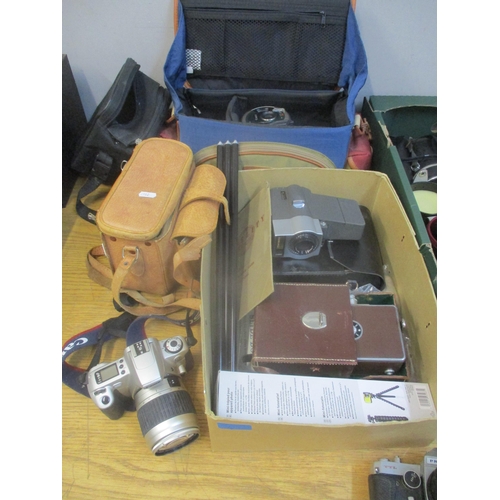 41 - A selection of film and digital cameras, lens, camera bags and accessories to include a Canon E05 30... 