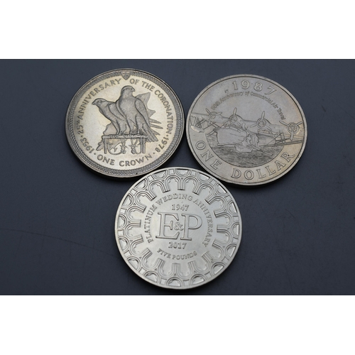 24 - Three Elizabeth II Commemorative Coins - Jersey Platinum Wedding £5, Coronation Isle of man 1978 and... 