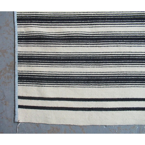 18 - Two antique narrow loom Welsh woollen blankets; one with black stripes of different width and the ot... 