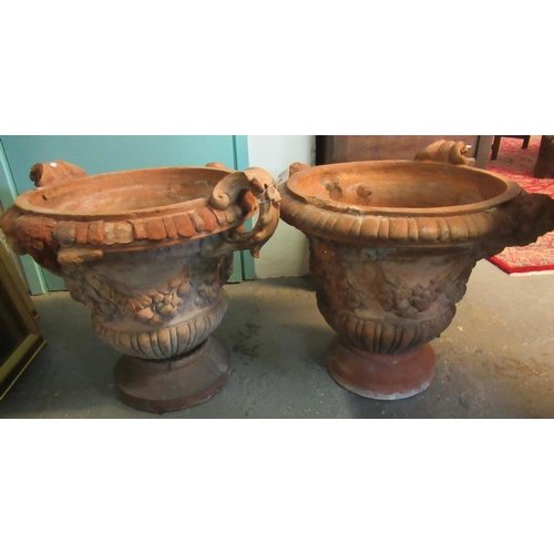 59 - Pair of terracotta campana shaped urns with leaf and mask mounts, the bodies relief decorated with f... 