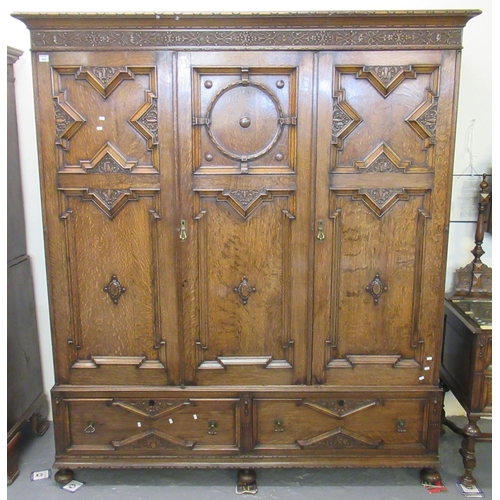 Early 20th Century oak, Jacobean style bedroom suite comprising: large triple door gentleman's wardrobe, mirror backed dressing table, straight fronted chest of four drawers and a pot cabinet. (Good quality) (4)
(B.P. 21% + VAT)