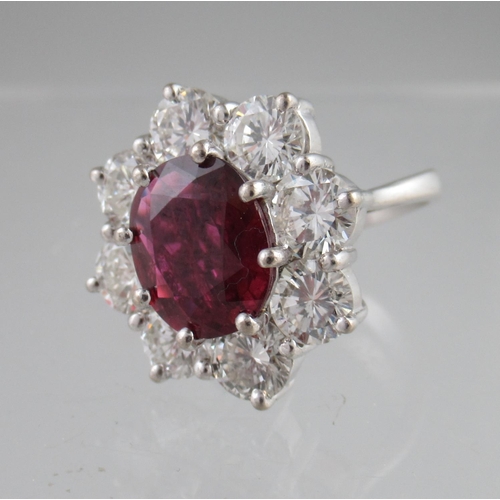 362 - Ruby and diamond ring the ruby an estimated 3.8cts surrounded by eight diamonds, estimated total dia... 